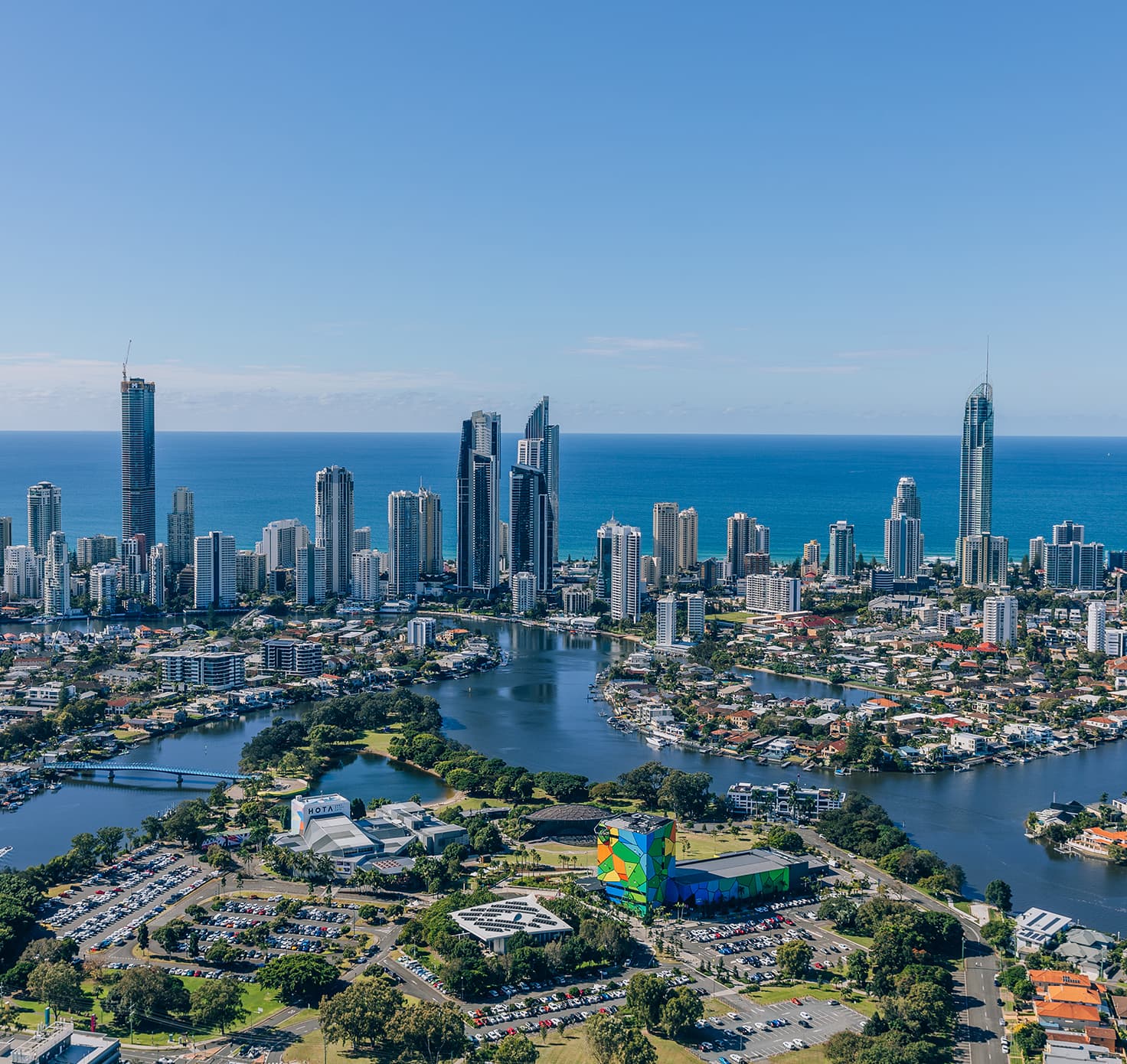 Aerial view of Bundall and Surfers Paradise waterways, city skyline, HOTA Gallery and the ocean.