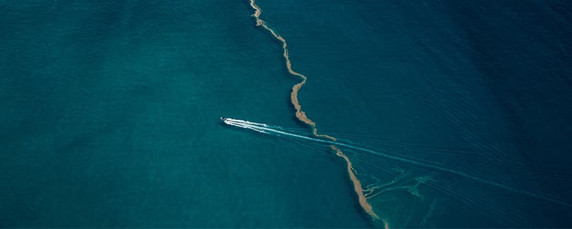 A luxury boat speeds across the ocean.