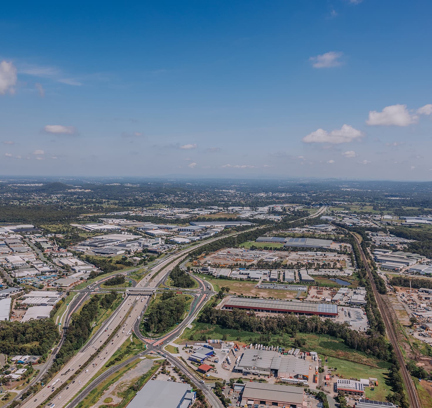 An aerial view of a highway and industrial area.