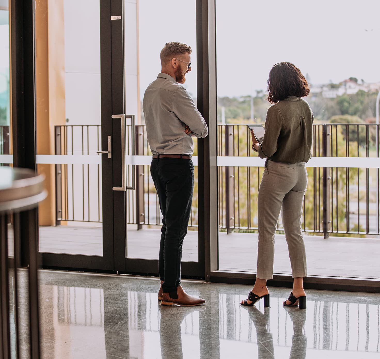 Two people standing and having a casual discussion.