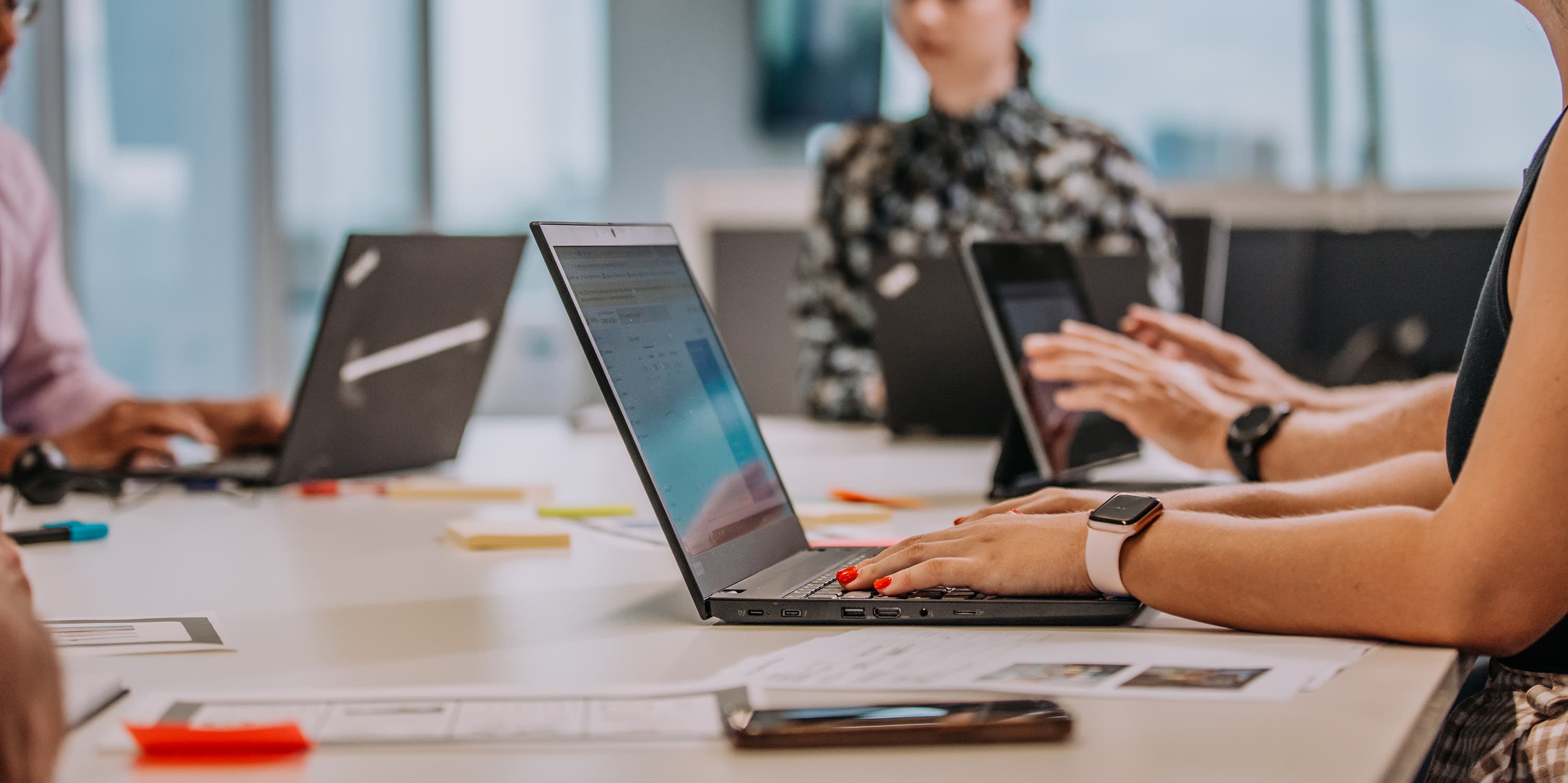 People typing on laptops.