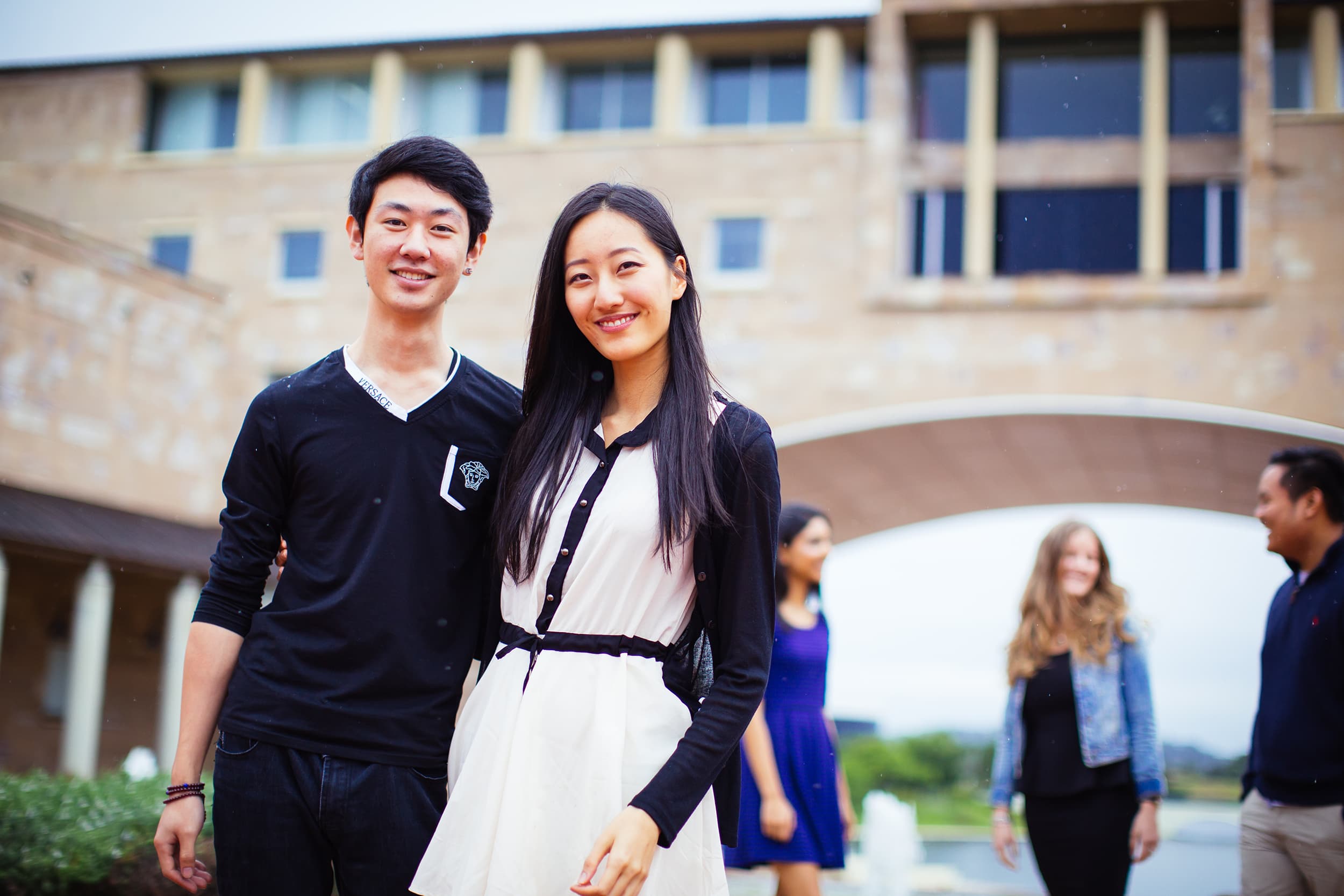 A couple of friends standing together and smiling.