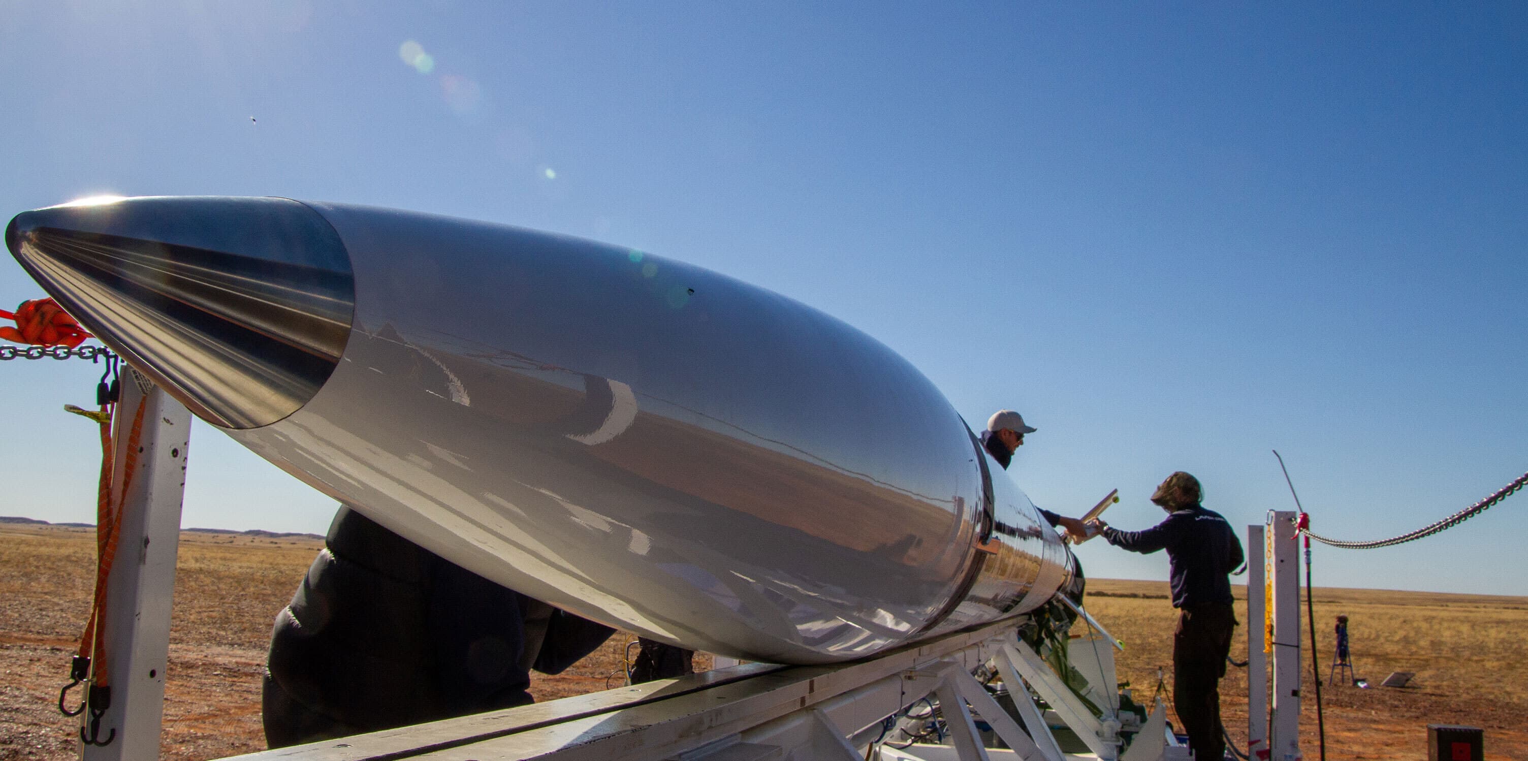 Technicians work on a Gilmour Space rocket.