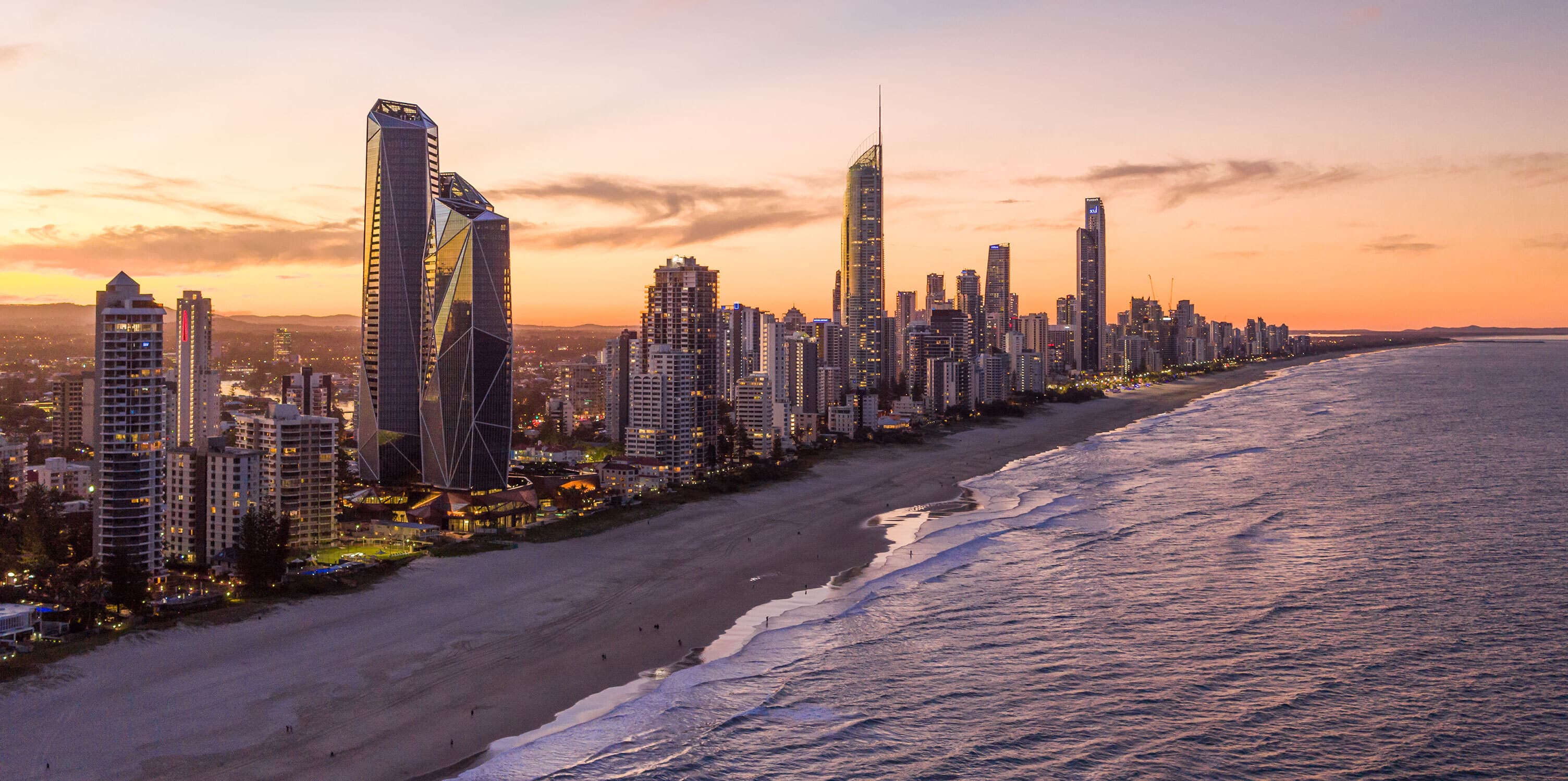 City skyline on the beachfront at sunset.
