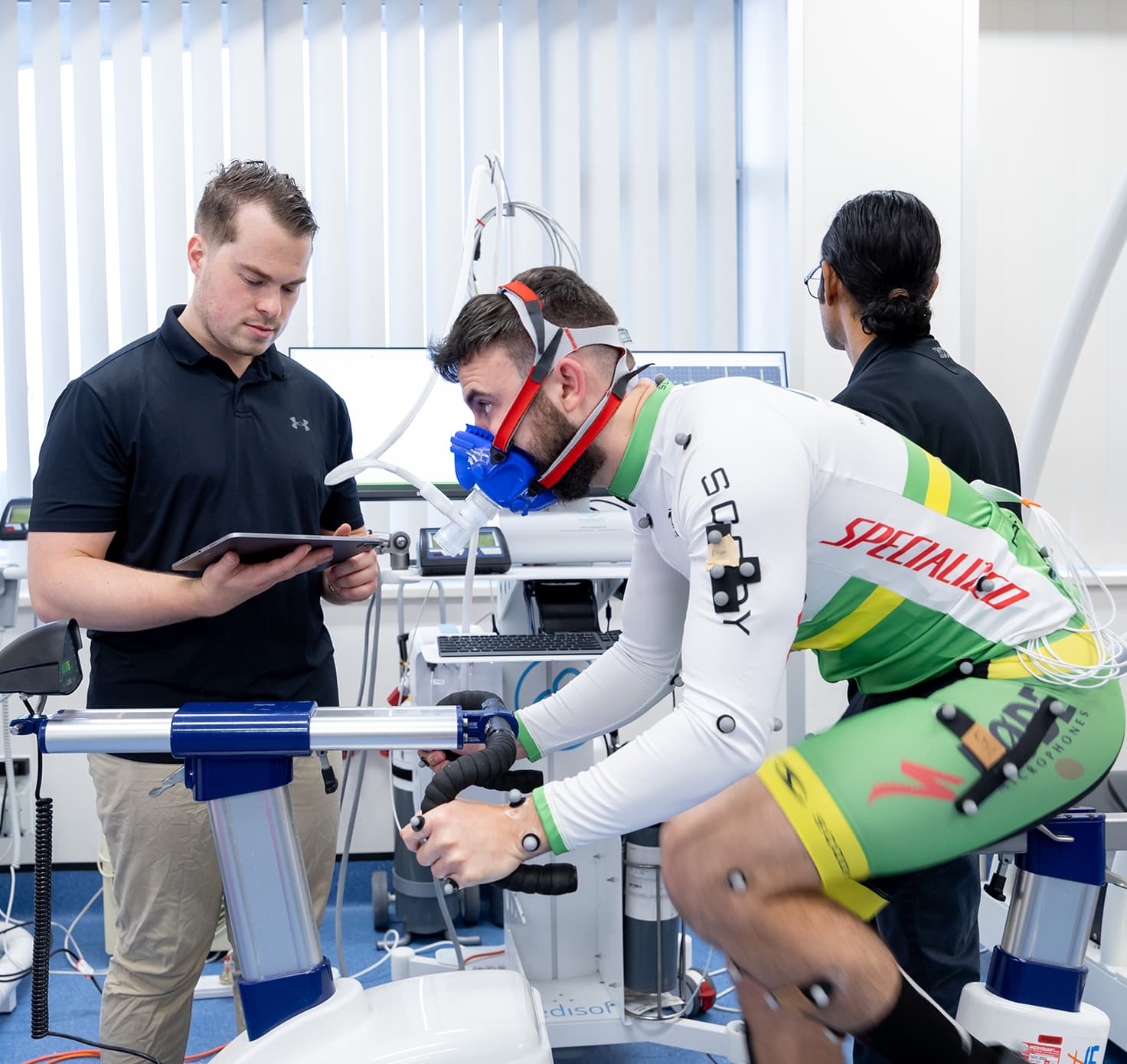 A sports scientist testing a cyclist.