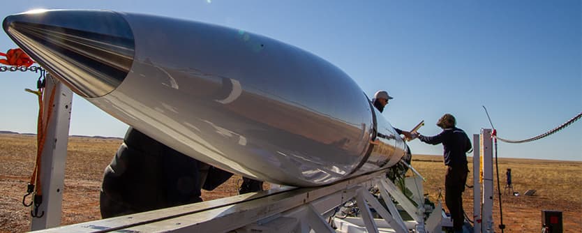 Technicians working on a rocket for Gilmour Space Technologies.