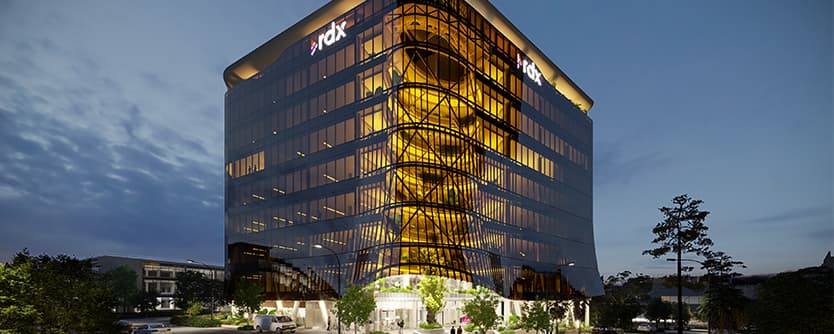 A render of a Gold Coast building lit up at night.
